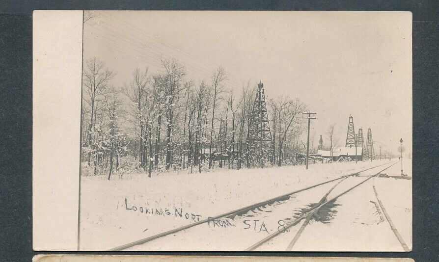 oil wells in winter: looking north from Station 8, railroad switch rppc postcard