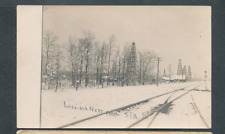 oil wells in winter: looking north from Station 8, railroad switch rppc postcard picture
